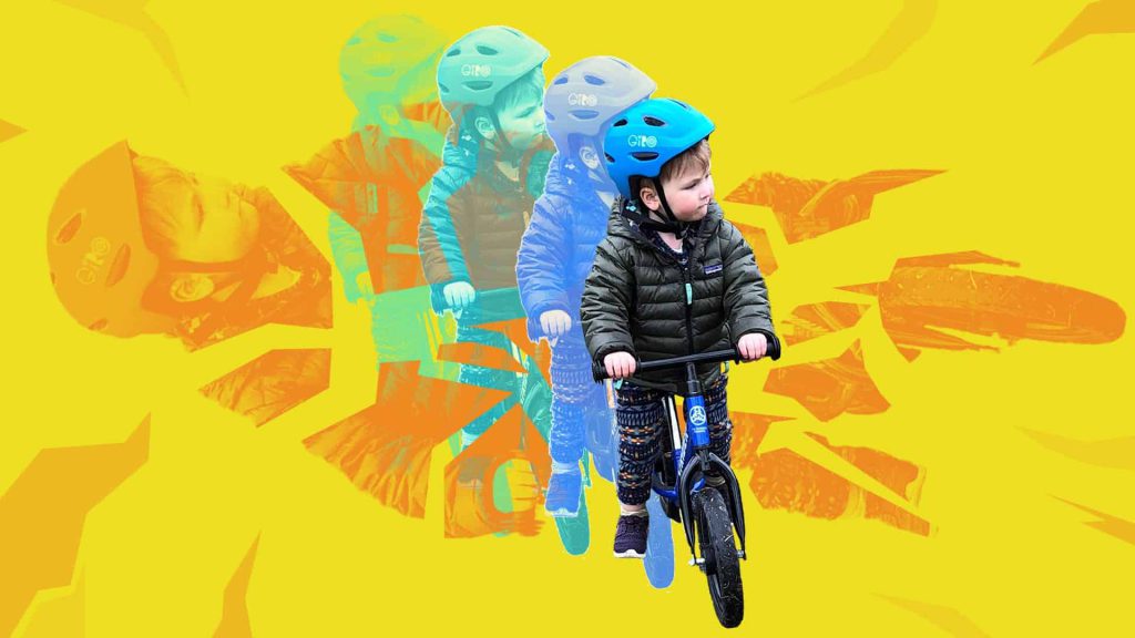 Child riding a bike with a helmet