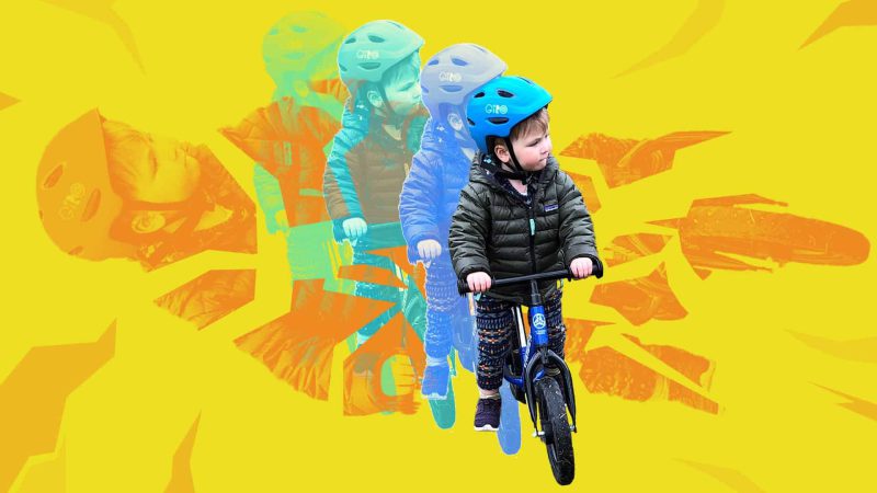 Child riding a bike with a helmet
