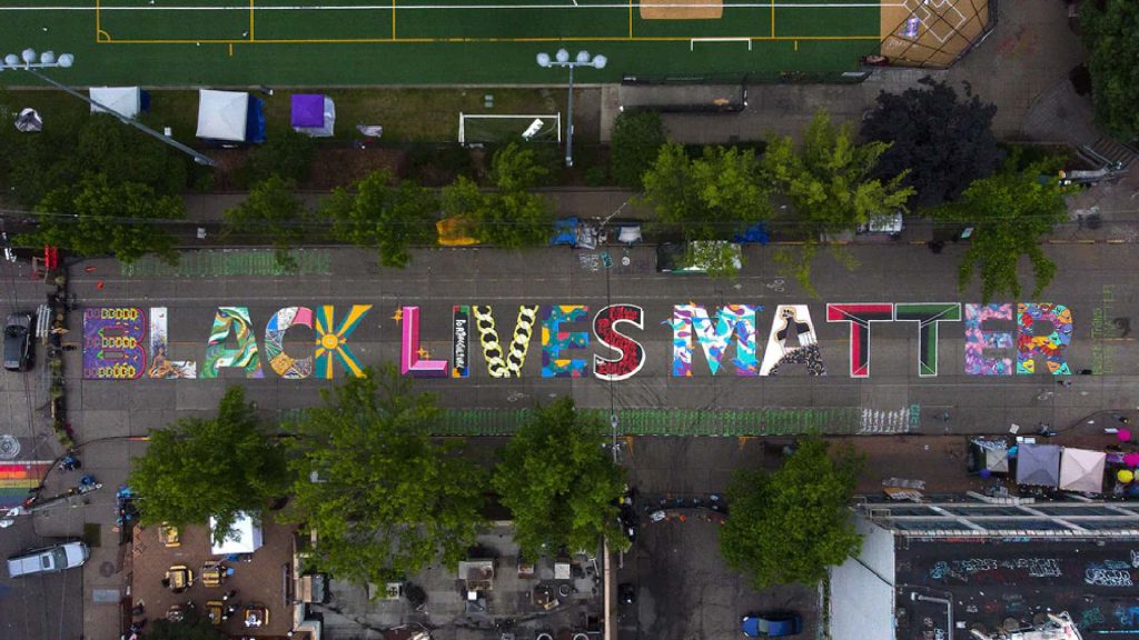 Image of a street with the words "black lives matter" painted on it
