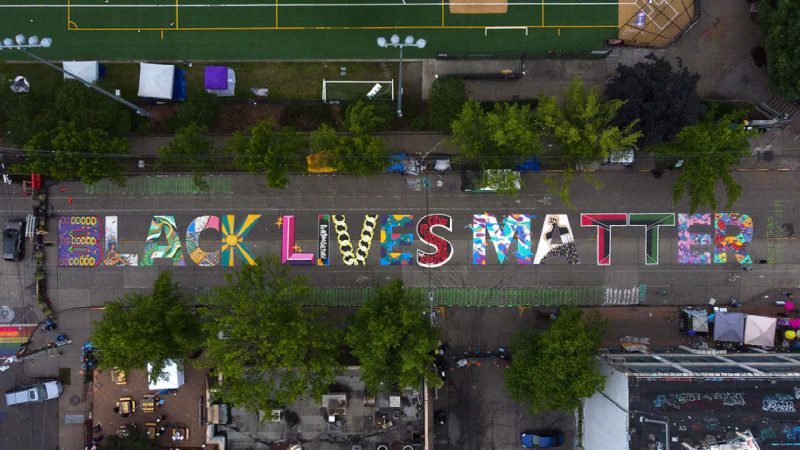 Image of a street with the words "black lives matter" painted on it